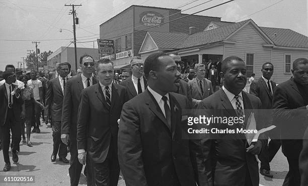 View of the procession of mourners on their way to Medgar Evers' funeral, Jackson, Mississippi, June 15, 1963. Evers was a Civil Rights activist who...