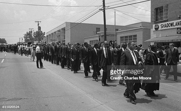 View of the procession of mourners on their way to Medgar Evers' funeral, Jackson, Mississippi, June 15, 1963. Evers was a Civil Rights activist who...