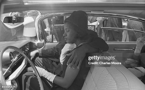View of American Civil Rights activist Myrlie Evers in a car during the funeral procession for her husband, Medgar Evers, Jackson, Mississippi, June...