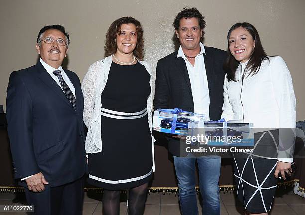 Carlos Vives and Yahaira Gamiochipi Sanabria, Director of Escuela Secundaria Técnica 31 Roberto Medellín Ostos attend the Latin Grammy en las...