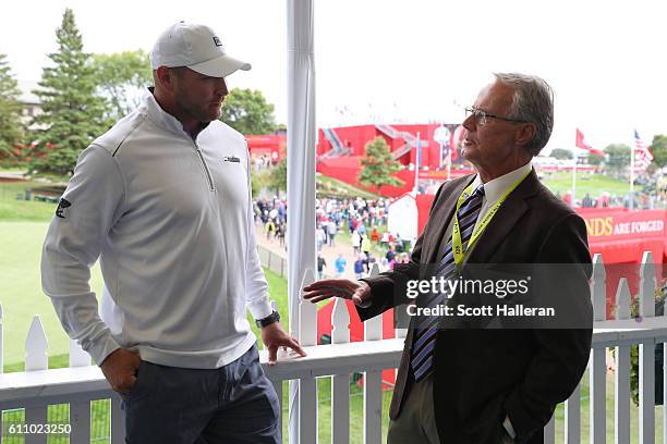 Former NFL player Brian Urlacher speaks to TV personality Mark Rolfing prior to the 2016 Ryder Cup at Hazeltine National Golf Club on September 28,...