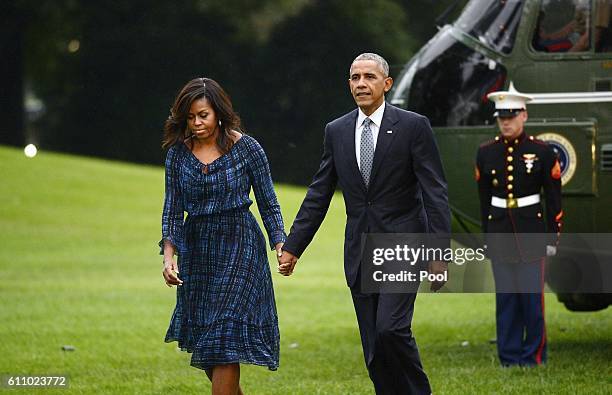 President Barack Obama and First Lady Michelle Obama walk on the south lawn of the White House on September 28, 2016 in Washington, DC. Earlier today...