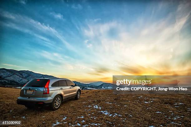 a car leaving into the sunset - sports utility vehicle bildbanksfoton och bilder