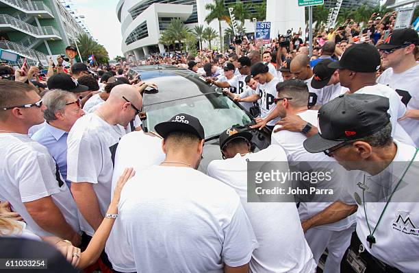 Miami Marlins owner, Jeffrey Loria, along with players and other members of the Marlins organization and their fans gather next to the hearse...