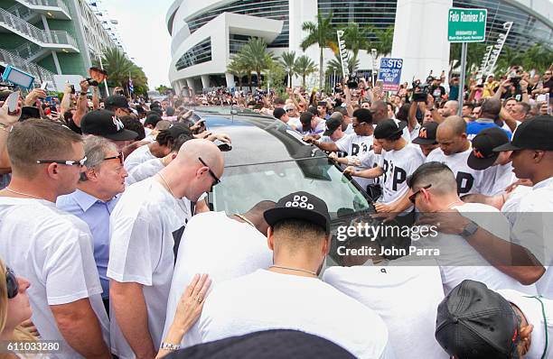 Miami Marlins owner, Jeffrey Loria, along with players and other members of the Marlins organization and their fans gather next to the hearse...