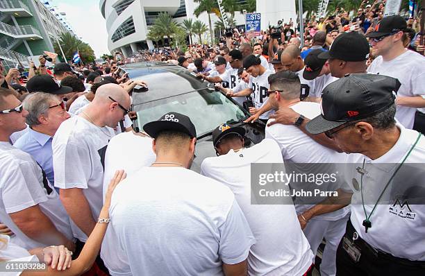 Miami Marlins owner, Jeffrey Loria, along with players and other members of the Marlins organization and their fans gather next to the hearse...