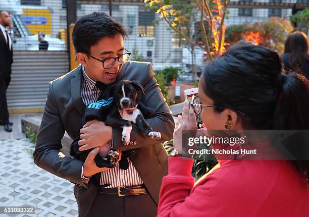 Puppy and a guest attend the celebration of the launch of Rachael Ray's Nutrish DISH with a Puppy Party on September 28, 2016 in New York City.