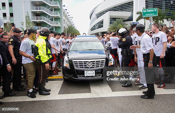 Miami Marlins owner, Jeffrey Loria, along with players and other members of the Marlins organization and their fans gather next to the hearse...