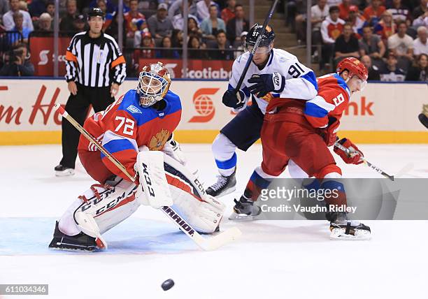 Sergei Bobrovsky tracks a loose puck with Dmitry Orlov of Team Russia and Aleksander Barkov of Team Finland battling in front during the World Cup of...