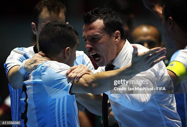 Diego Giustozzi the coach of Argentina reacts with Cristian Borruto of Argentina at the final whistle during the FIFA Futsal World Cup Semi Final...