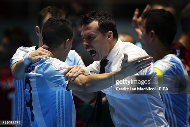 Diego Giustozzi the coach of Argentina reacts with Cristian Borruto of Argentina at the final whistle during the FIFA Futsal World Cup Semi Final...