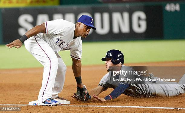 Texas Rangers third baseman Adrian Beltre, left, tags out the Milwaukee Brewers' Hernan Perez while trying to steal third base in the third inning at...