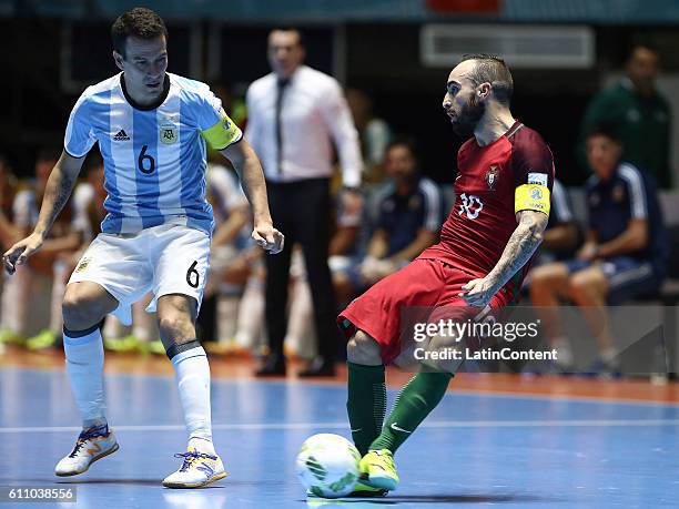 Ricardinho of Portugal plays the ball as Fernando Wilhelm of Argentina defends during a semi final match between Argentina and Portugal as part of...