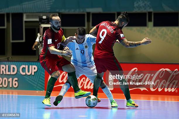 Cristian Borruto of Argentina battles with Ricardinho of Portugal and Joao Matos of Portugal during the FIFA Futsal World Cup semi-final match...