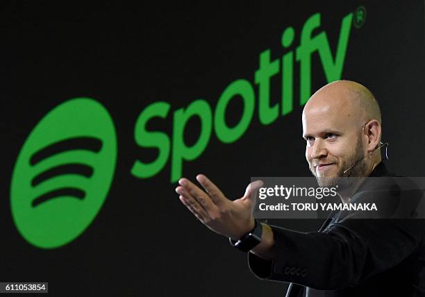 Daniel Ek, CEO of Swedish music streaming service Spotify, gestures as he makes a speech at a press conference in Tokyo on September 29, 2016....
