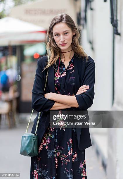 German model Franzi Mueller wearing a dress with floral print outside Lanvin on September 28, 2016 in Paris, France.