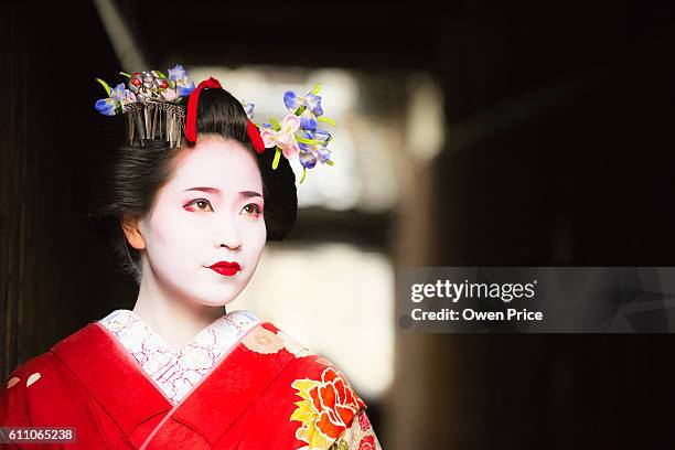 maiko emerging into the light gion kyoto - geisha in training stock pictures, royalty-free photos & images