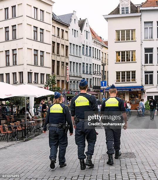 three police are walking in the streets of antwerp,belgium - antwerp city belgium stock pictures, royalty-free photos & images