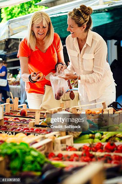 women buying fruit from a market stall - local market stock pictures, royalty-free photos & images