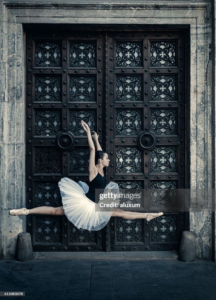 Ballet dancer jumping in the street