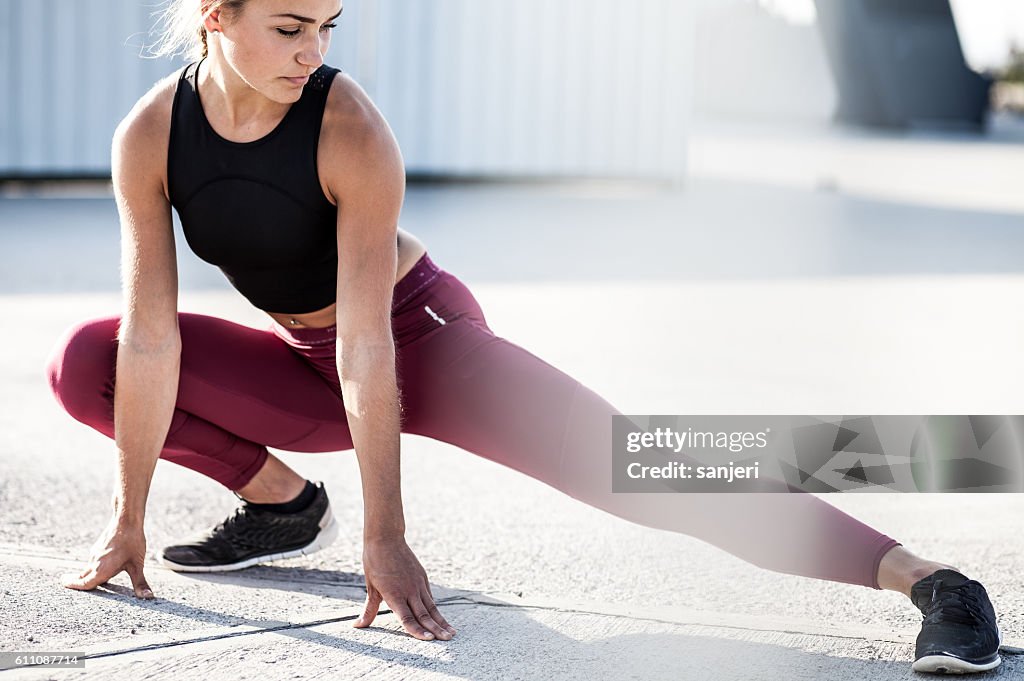 Female Athlete Stretching Outdoors