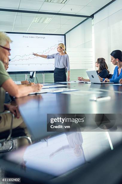 businesswoman presenting revenue growth - financial analyst stock pictures, royalty-free photos & images