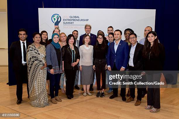 Photograph of US Secretary of State John Kerry taking a group photograph with the alumni of the State Department's Bureau of Educational and Cultural...