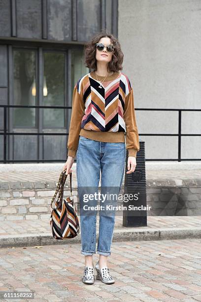 Oyster fashion editor Chloe Hill wears Sonia Rykiel top, Levi"u2019s jeans, Coach shoes and Jerome Dreyfus sunglasses day 3 of London Womens Fashion...