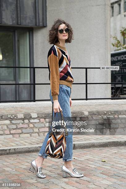 Oyster fashion editor Chloe Hill wears Sonia Rykiel top, Levi"u2019s jeans, Coach shoes and Jerome Dreyfus sunglasses day 3 of London Womens Fashion...