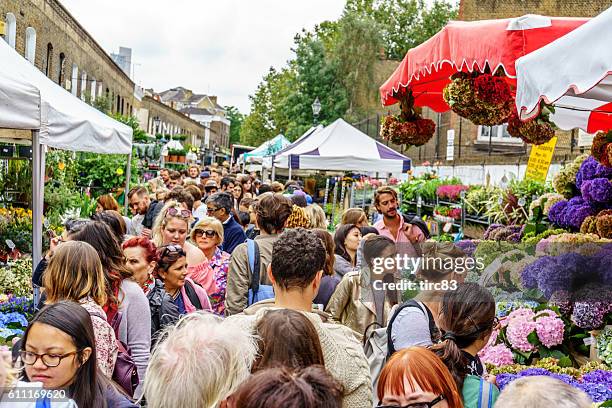 shoppers at london street market - columbia road stock pictures, royalty-free photos & images