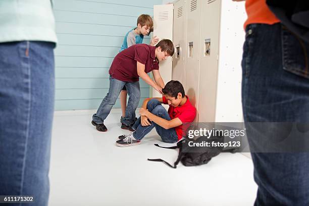 teenage boys bully classmate in school hallway. - racism stock pictures, royalty-free photos & images