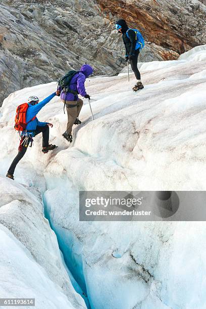 teamwork on the icy glacier - crevasse stock pictures, royalty-free photos & images