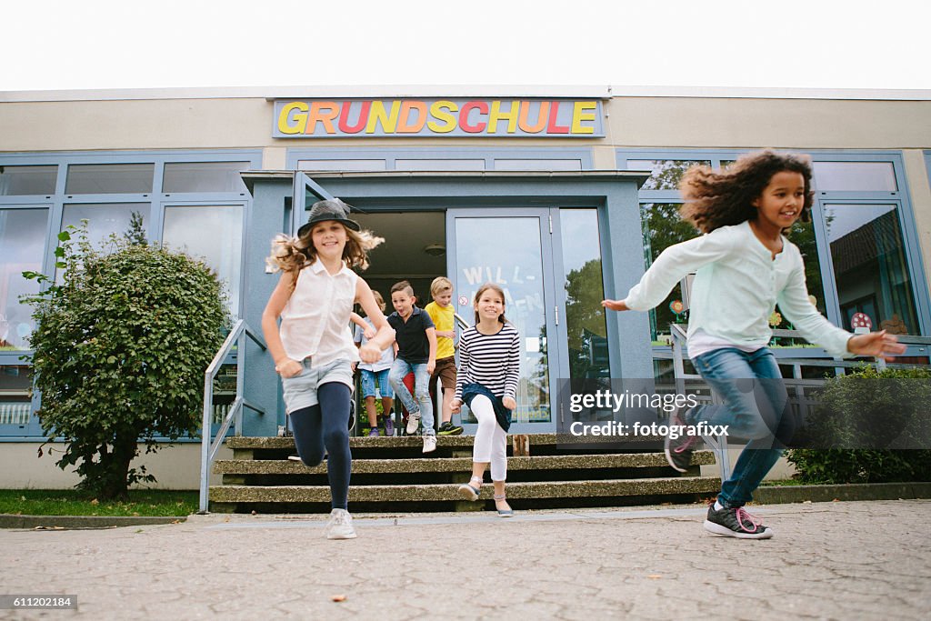 Grundschüler laufen die Schule zum Schulhof