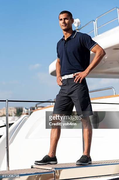 young man standing on ferry - destination fashion 2016 stockfoto's en -beelden