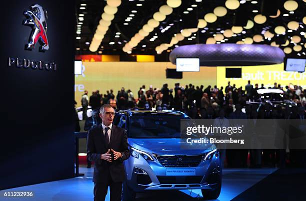 Carlos Tavares, chief executive officer of PSA Peugeot Citroen, speaks beside the new Peugeot 3008 sport-utility vehicle on the first press day of...