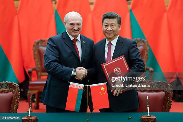 Chinese President Xi Jinping shakes hands with Belarusian President Alexander Lukashenko during a signing ceremony at the Great Hall of the People on...
