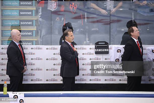 Assistant coach John Hynes of Team USA and head coach John Tortorella and assistant coach Phil Housley stand for the playing of the American national...