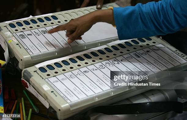 Election officers check the electronic polling board at Dr Antonia De silva High School in Dadara day before the elections on Wednesday.