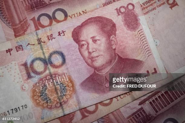 This photo illustration taken on September 29, 2016 shows Chinese 100 yuan notes in Beijing.