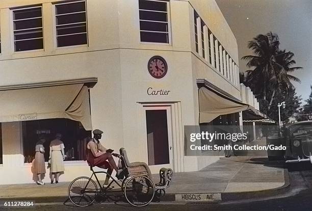 African-American pedicab operator waiting outside a Cartier jewelry store in Palm Beach, Florida, 1939. From the New York Public Library. Note: Image...