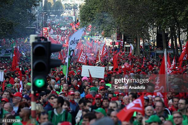 People gather to protest against the center-right government's austerity policy after various labor unions called for a demonstration in Brussels,...