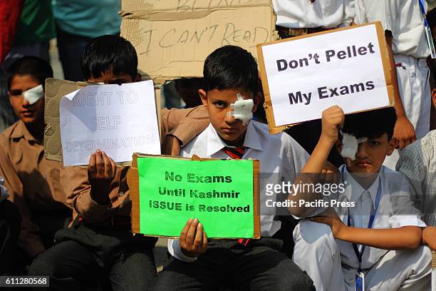 With one eye blind-folded, the students wearing uniform protests conveying no exams till resolution of Kashmir issue in Indian controlled Kashmir....