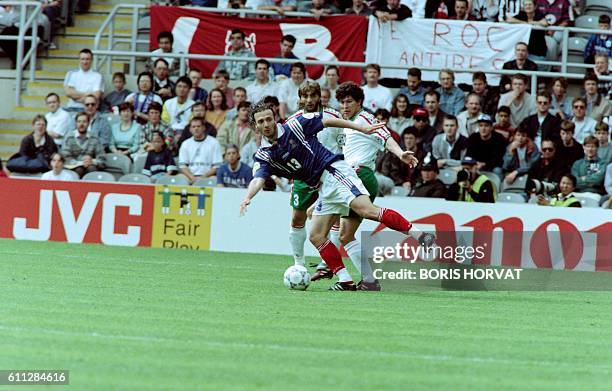 French Christophe Dugarry fights for the ball with Bulgarians Trifon Ivanov and Krasimir Balakov during the last match of the group B between France...