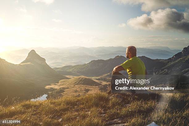 meeting dawn on top of the mountain - man on top of mountain stock pictures, royalty-free photos & images