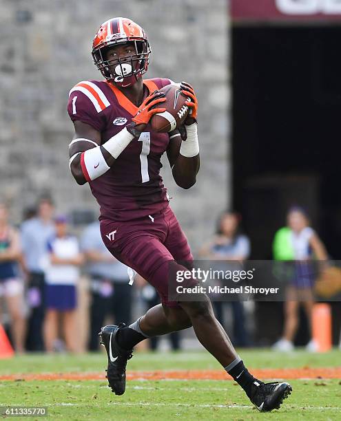 Wide receiver Isaiah Ford of the Virginia Tech Hokies looks to pass during a trick play against the East Carolina Pirates in the first half at Lane...