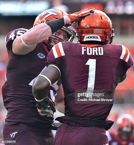 Full back Sam Rogers of the Virginia Tech Hokies celebrates with wide receiver Isaiah Ford following his touchdown reception against the East...