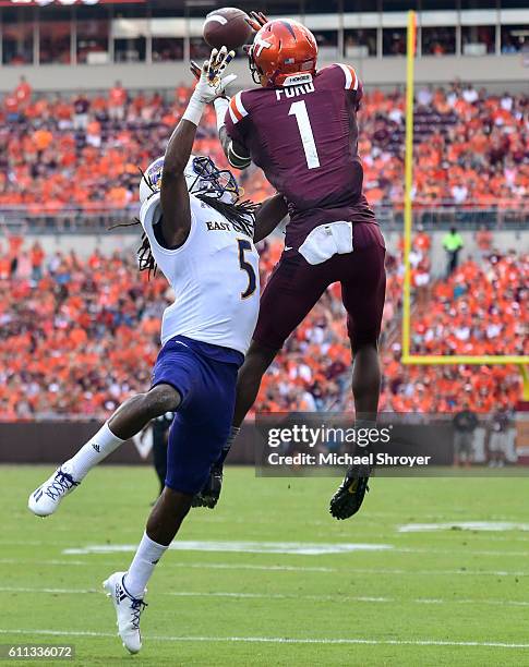 Wide receiver Isaiah Ford of the Virginia Tech Hokies catches a touchdown pass while being defended by defensive back Corey Seargent of the East...