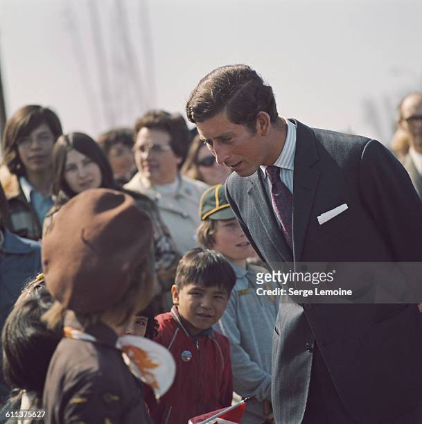 Charles, Prince of Wales talking to a group of children during a tour of Canada, April 1975.