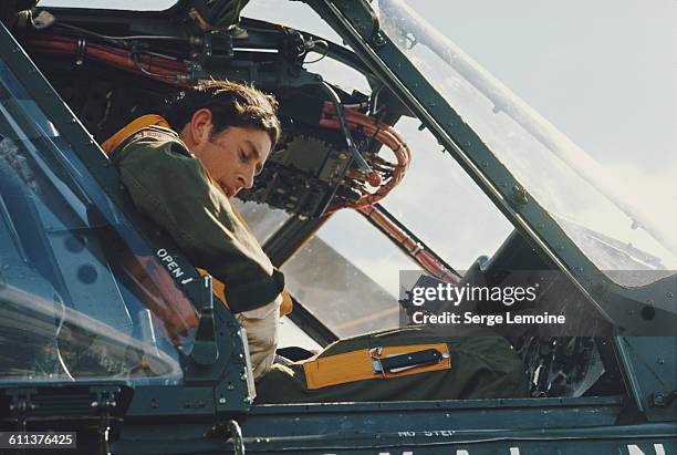 Charles, Prince of Wales sits in the cockpit of a Royal Navy Wessex helicopter, during a flying lesson at the Royal Naval Air Station in Yeovilton,...