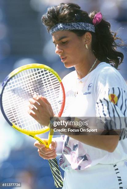 Tennis player Gabriela Sabatini of Argentina checks the strings of her racket during the women 1994 U.S. Open Tennis Tournament at the USTA National...